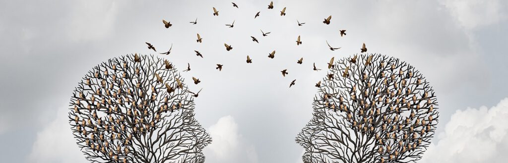 Two trees shaped like heads facing each other. Birds fly between the branches. Illustration.