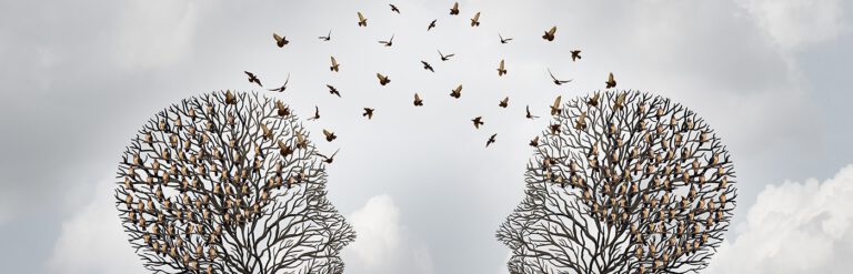 Two trees shaped like heads facing each other. Birds fly between the branches. Illustration.