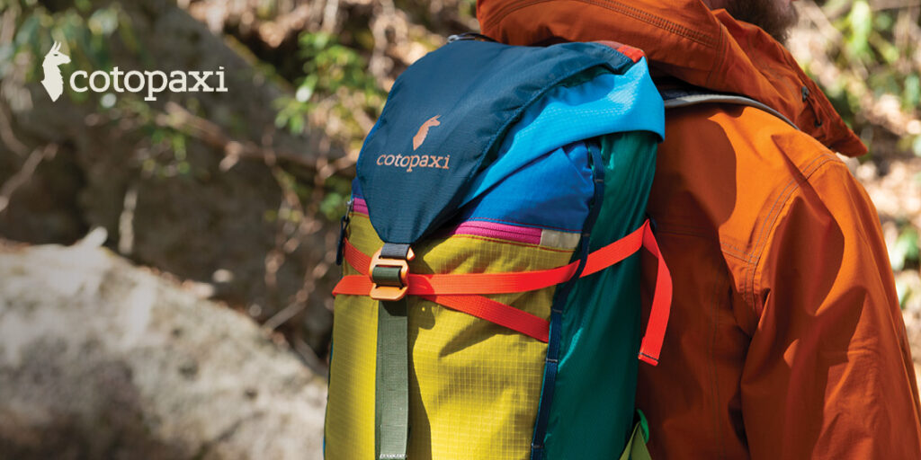 A colorful Cotopaxi backback on a hiker.