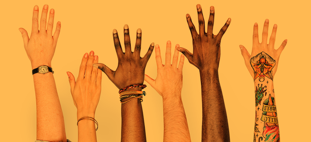 Diverse range of upraised hands.